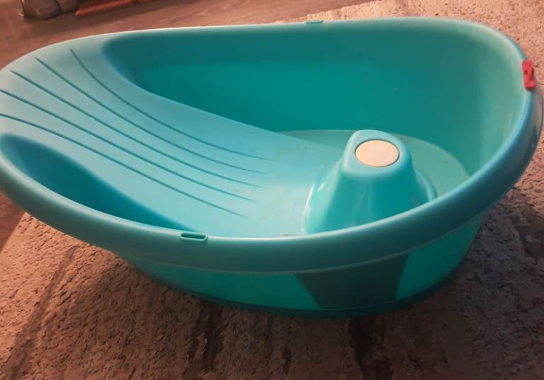 Blue baby bath tub with plug