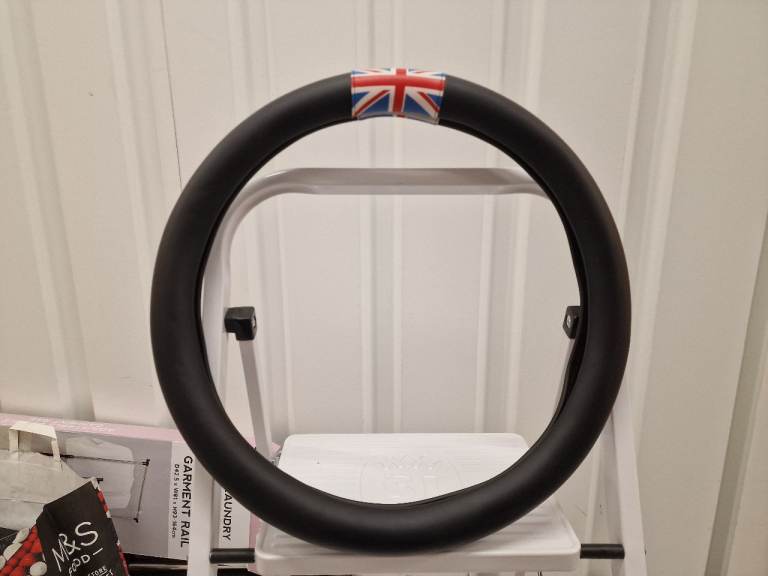 Black steering wheel cover with Union Jack top centre marker.