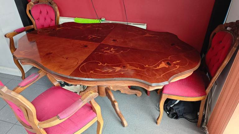 old dining table made with real wood. with chairs