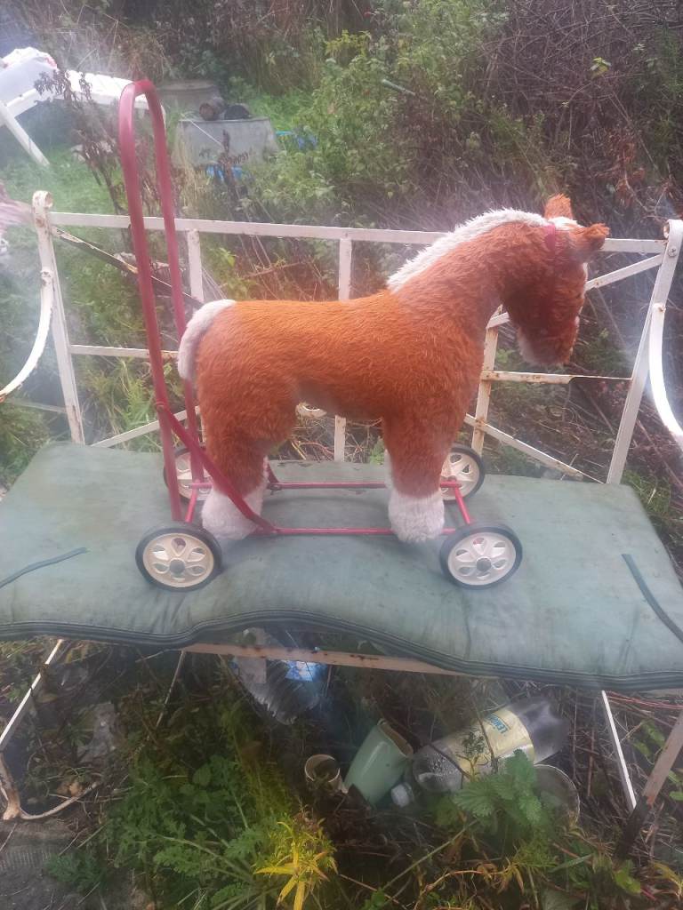 Pull along soft toy horse on wheels