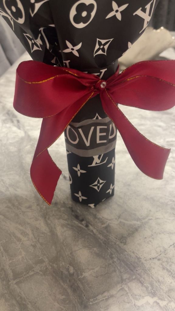 Red roses with diamonds on it wrapped in paper