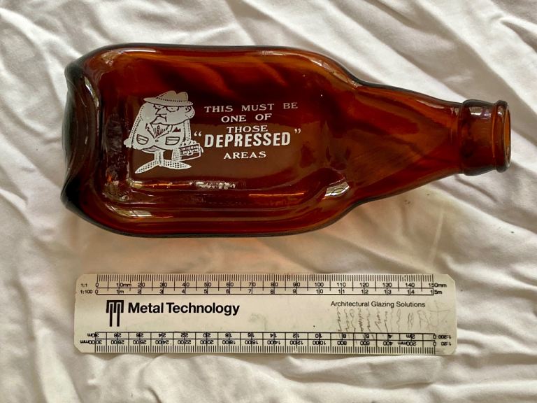 Vintage "Depressed Areas" Amber Glass Bottle