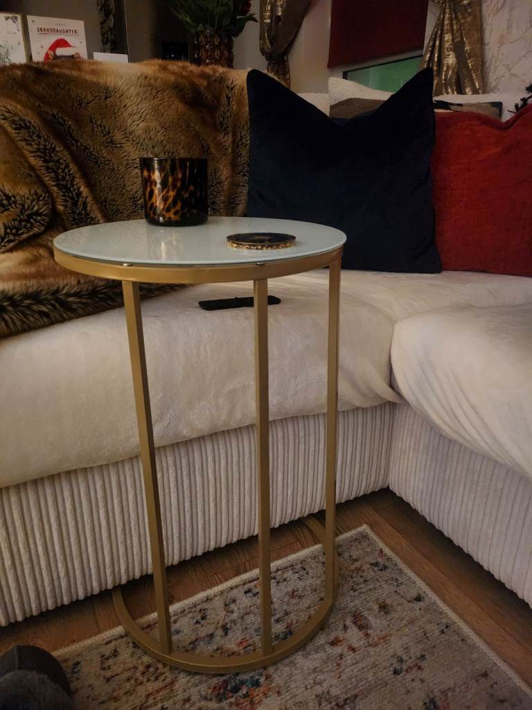 C shaped gold side table with white glass top