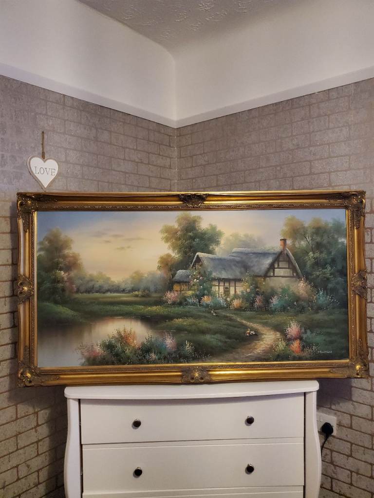 Vintage paintings in gold ornate gilt frames.