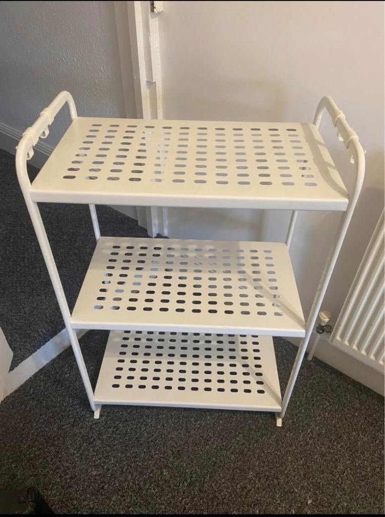 White metal shelving with hooks. 