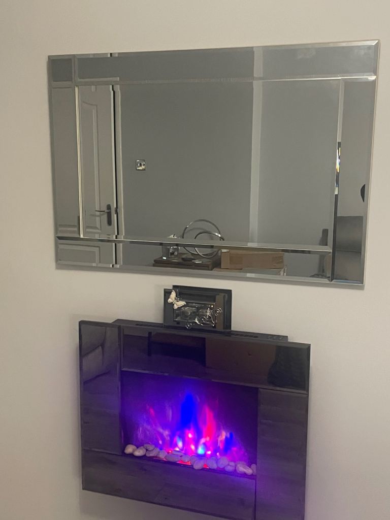 As  new electric fire with remote controls. Changes colour etc. also mirror to match . £60.00 Ono 