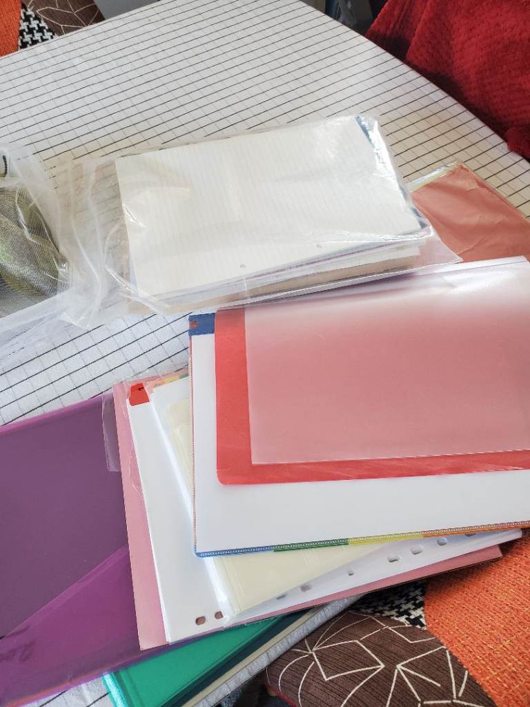Various sheets of A4 paper, Polly pockets and document covers