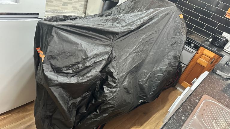 Black motorcycle cover with orange high visibility markers