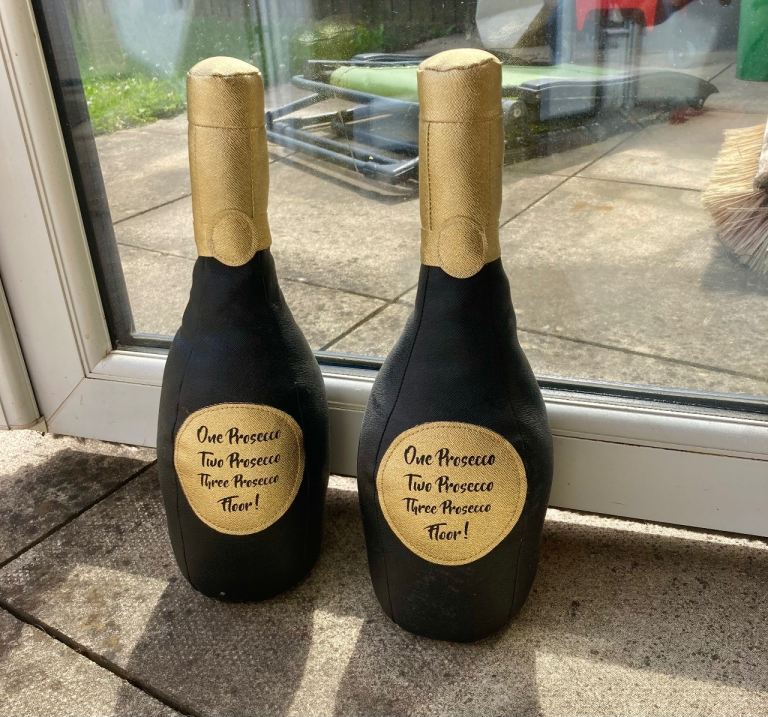 Pair of Novelty Prosecco Bottle Doorstops – Good Condition