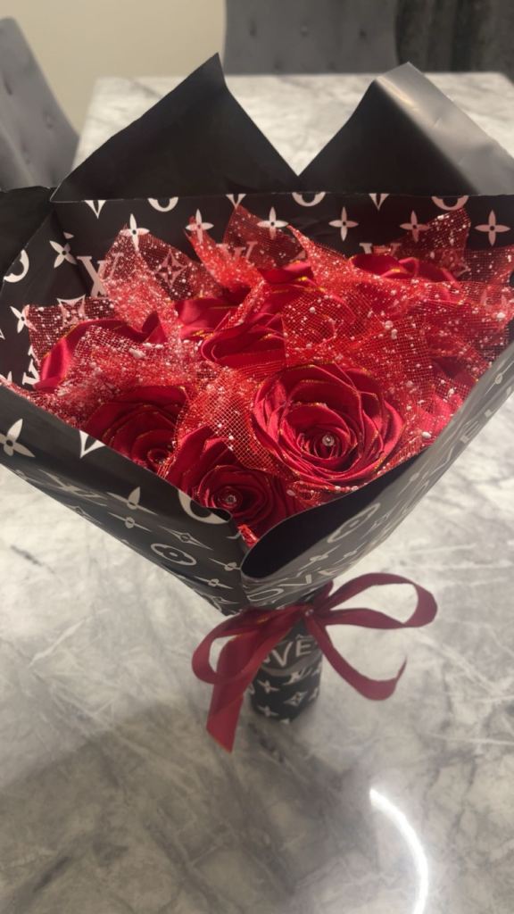 Red roses with diamonds on it wrapped in paper