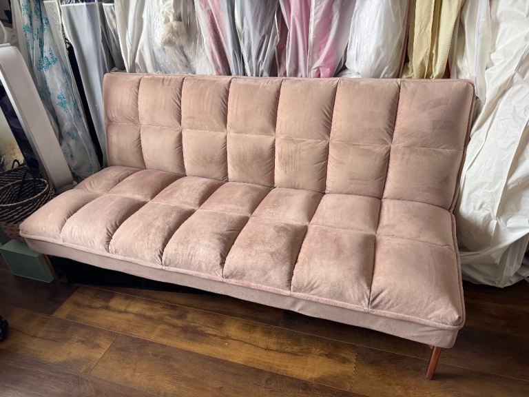 Pink velvet sofa bed by Made 