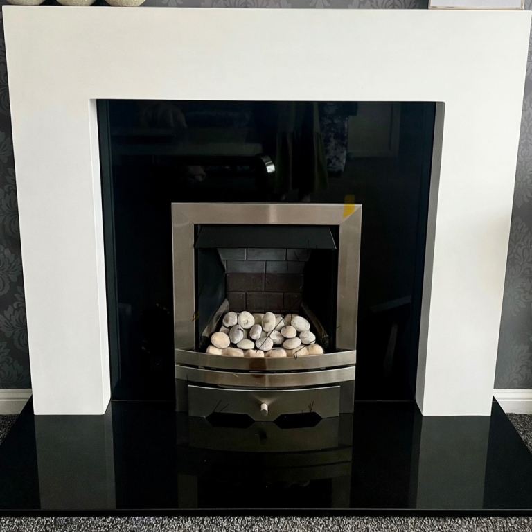White fire surround and black granite back and hearth