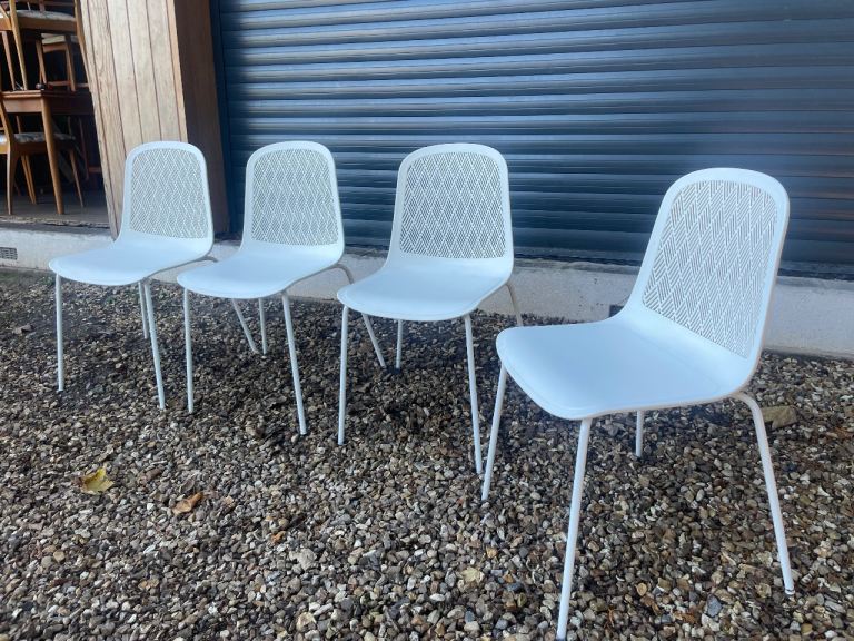 White polyethylene moulded dining chairs with decorative back rest