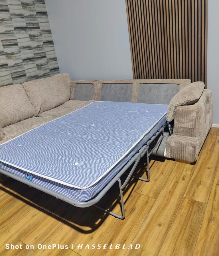 Large beige DFS Corner Sofa Bed  with footstool + free delivery