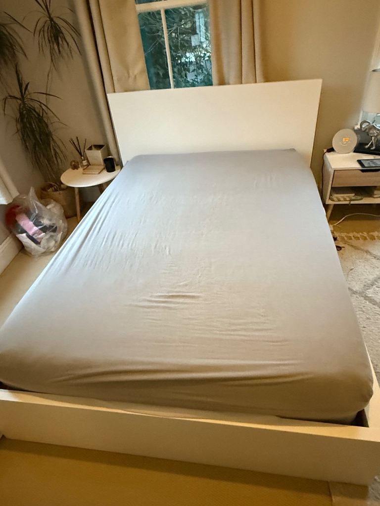 Double bed frame with mattress and topper