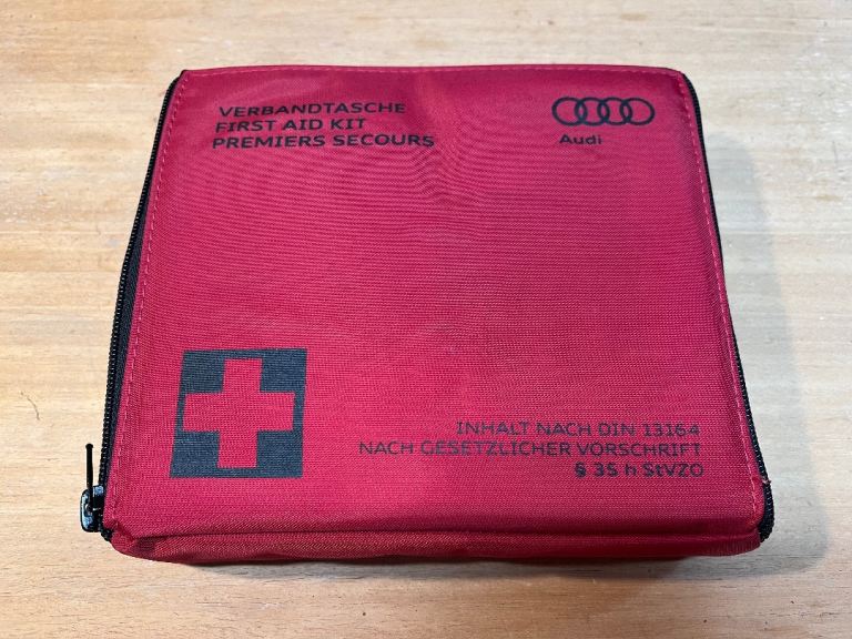 Audi A6 first aid kit. Unopened. Fits in the rear seat arm rest.