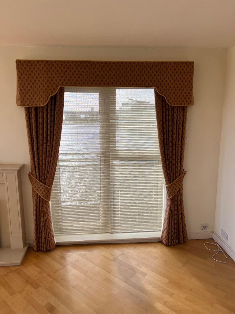 Pair of curtains with matching pelmet, lined with tie-backs.