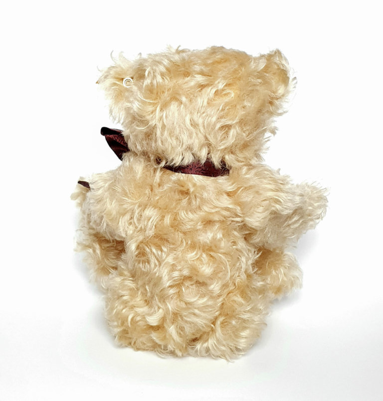 Steiff Bear with Bow and tag with gold plated button. Approx 12 inches