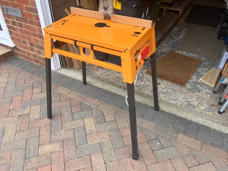 Triton RSA300 router table with scrolling jigsaw attachment.