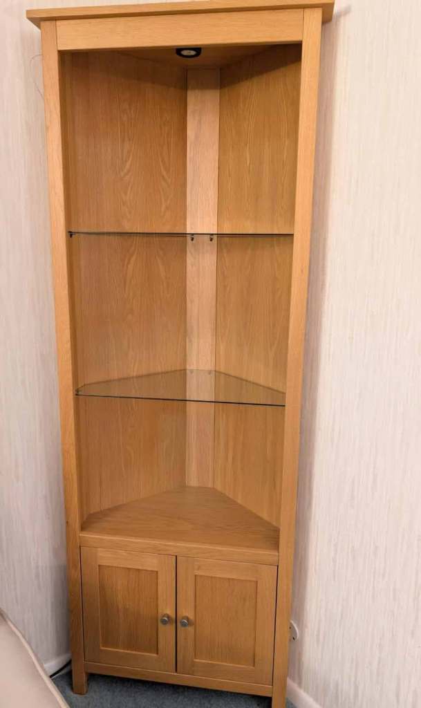 Tall corner display unit with glass shelves and  useful bottom cupboard 