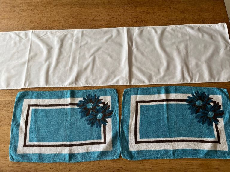 White table runner and two blue napkins