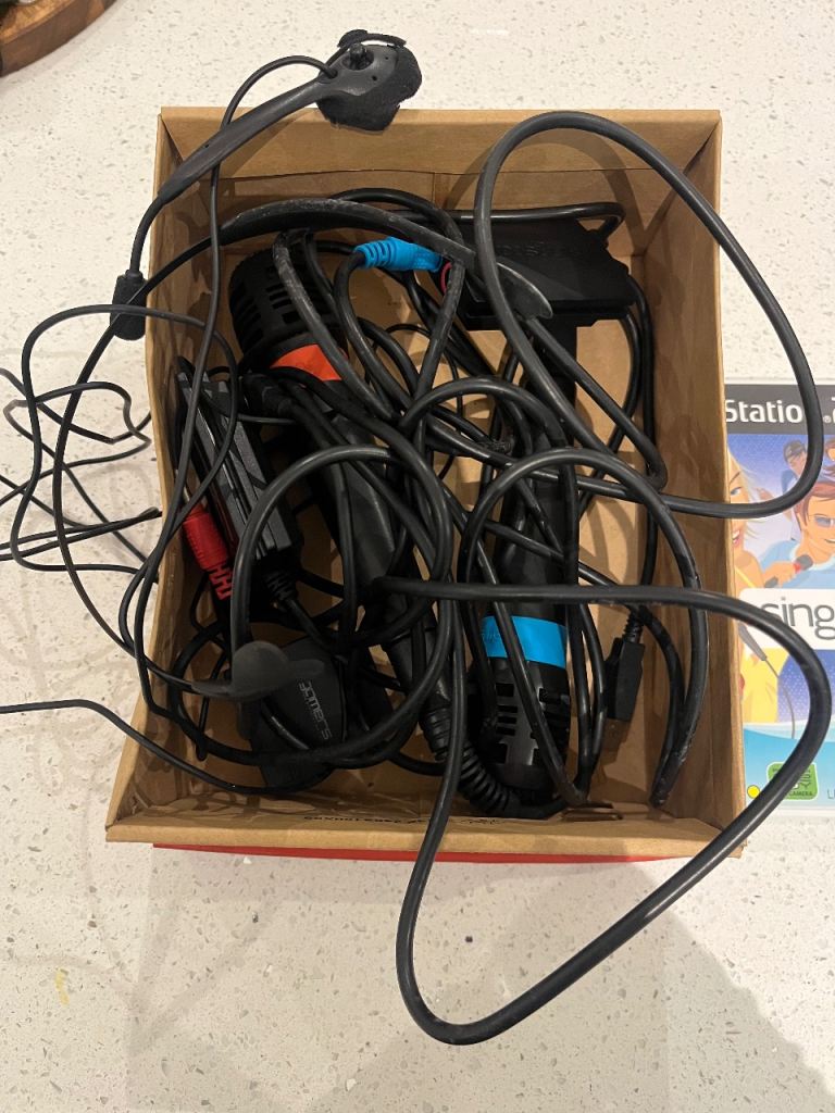 PlayStation 2 with games and microphones 