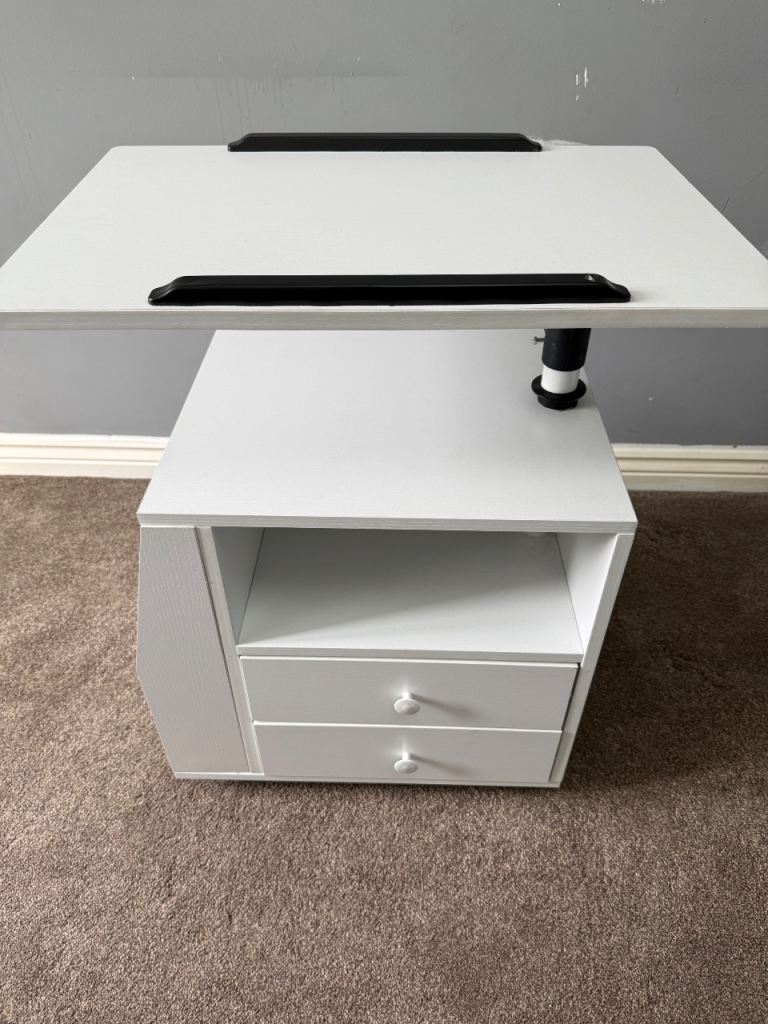 White bedside table top shelf rotates to bring closer to bed