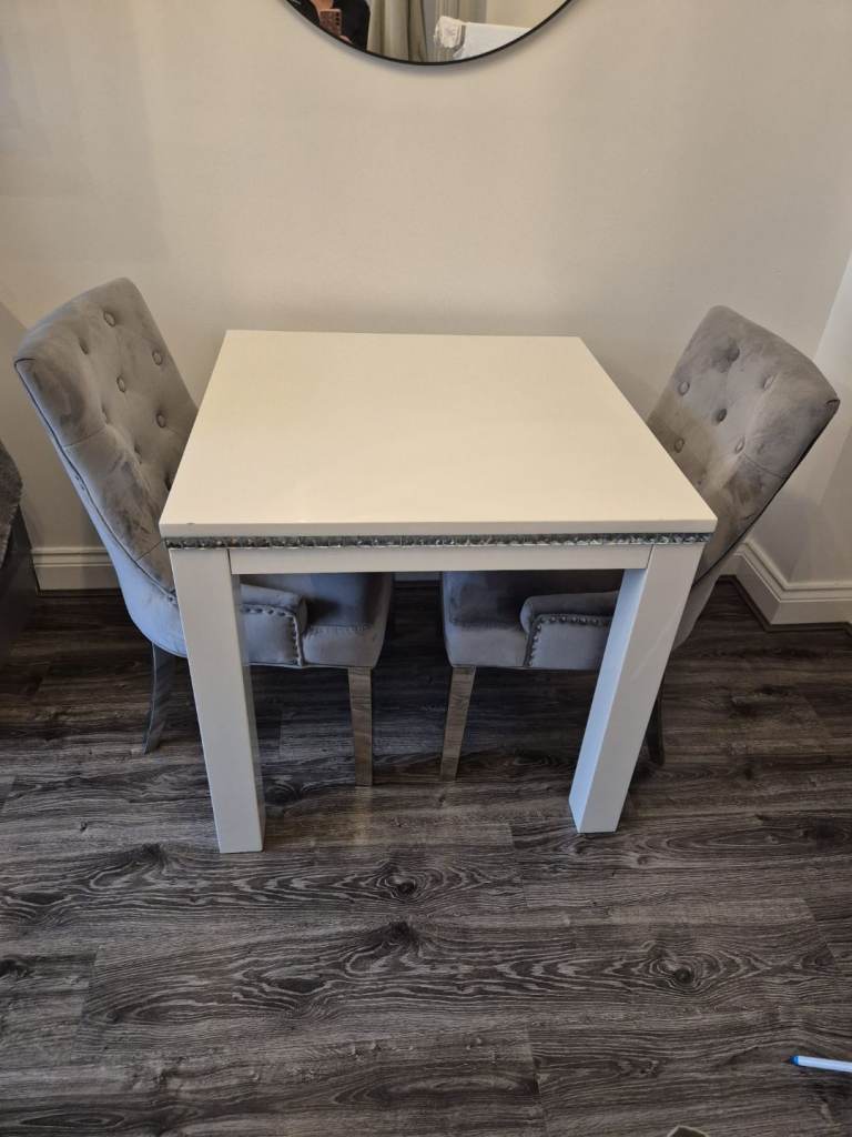 white high gloss table and and grey velvet chairs