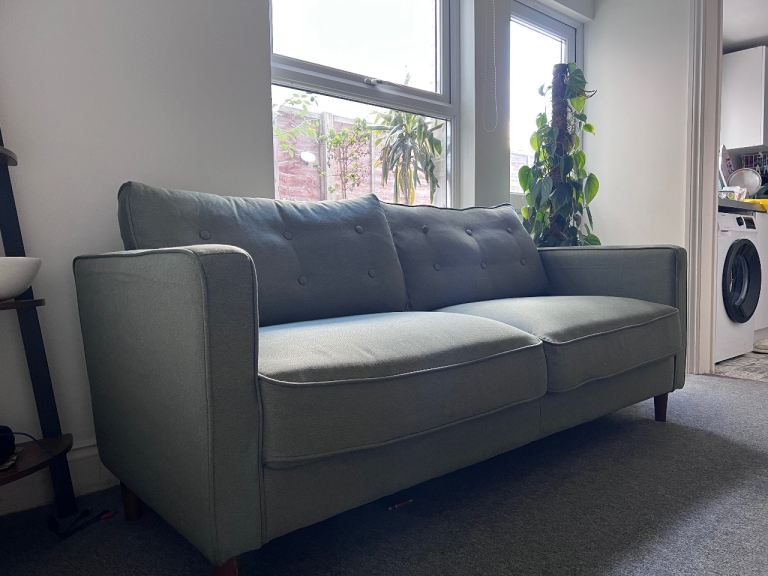 Large green comfortable sofa 