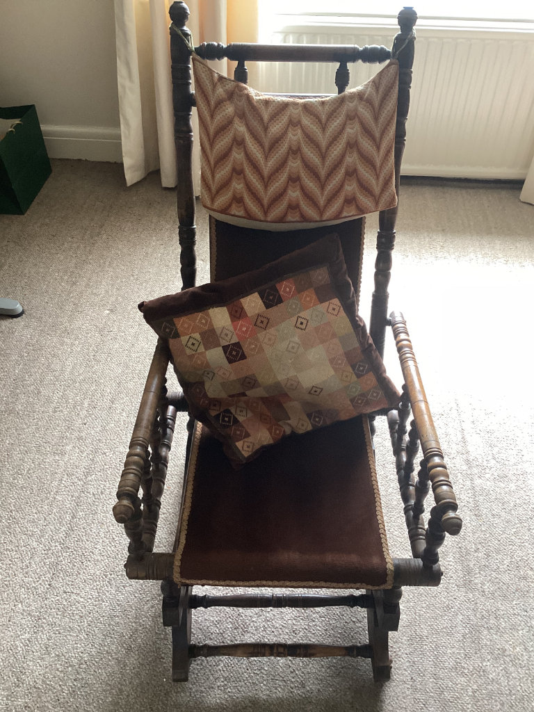ANTIQUE AMERICAN HARDWOOD ROCKING CHAIR, UPHOLSTERED IN BROWN VELVET.