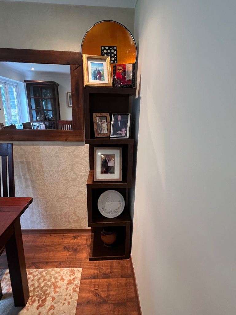 Dark wood corner shelving unit