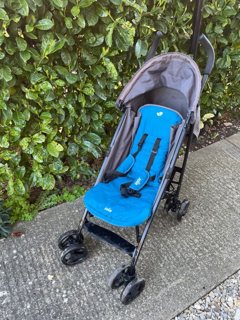 Joie blue buggy with rain cover and Red Kite sun cover 