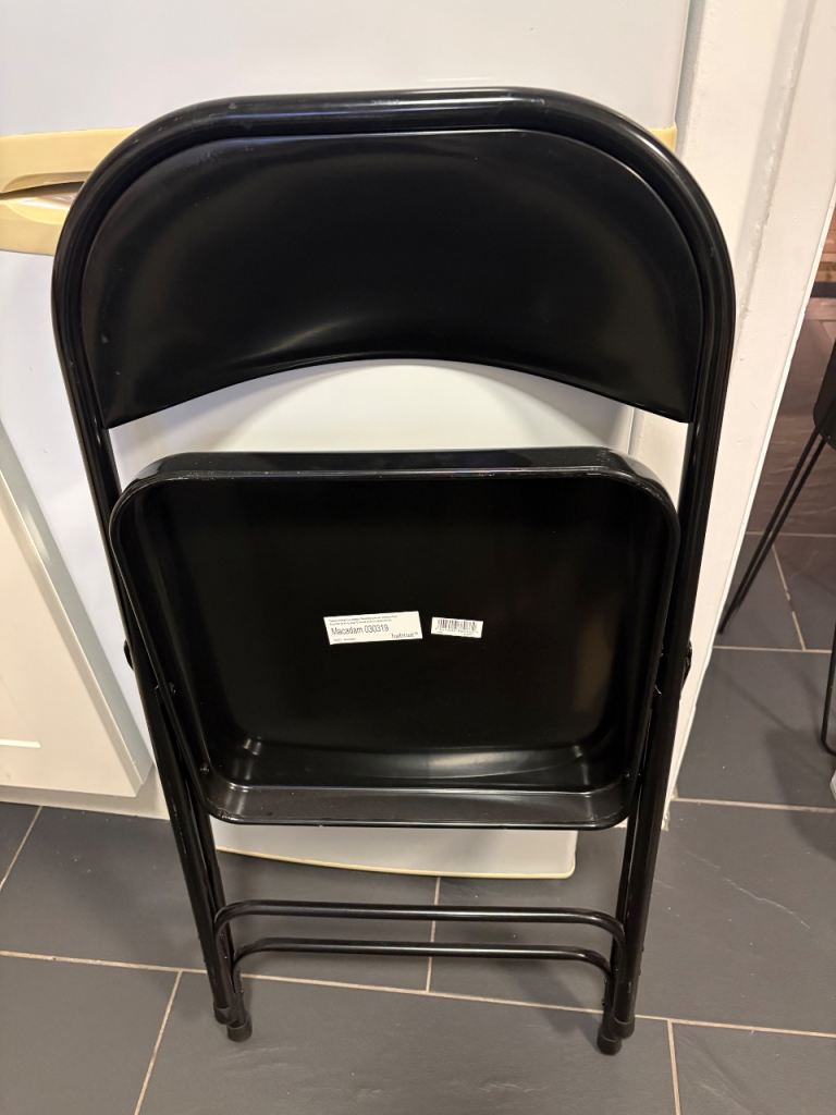 Two black habitat folding chairs