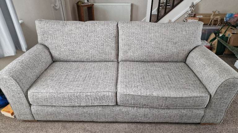 Comfortable two-seater sofa in neutral grey fabric, good condition