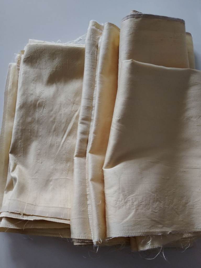 Pieces of pale-yellow silk fabric
