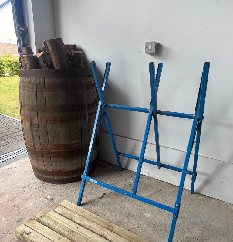 Logs, oak barrel & saw horse