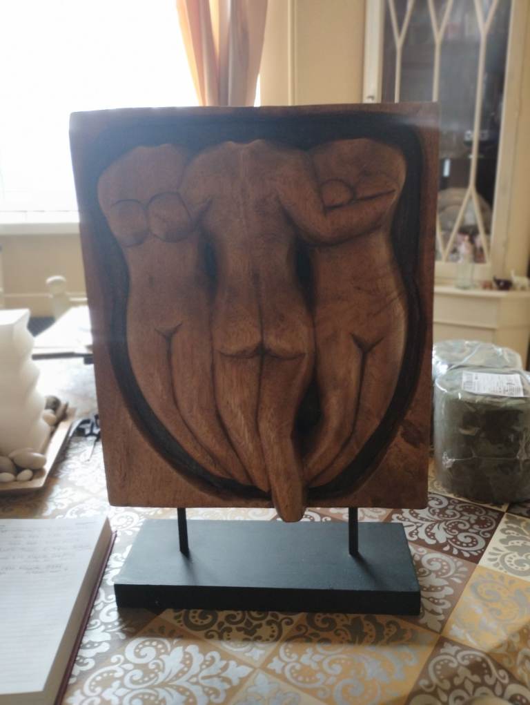 Carved wooden ornament female form.