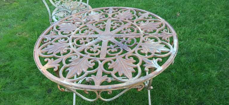 Wrought iron garden furniture set, vintage bistro set with a table and two chairs. 
