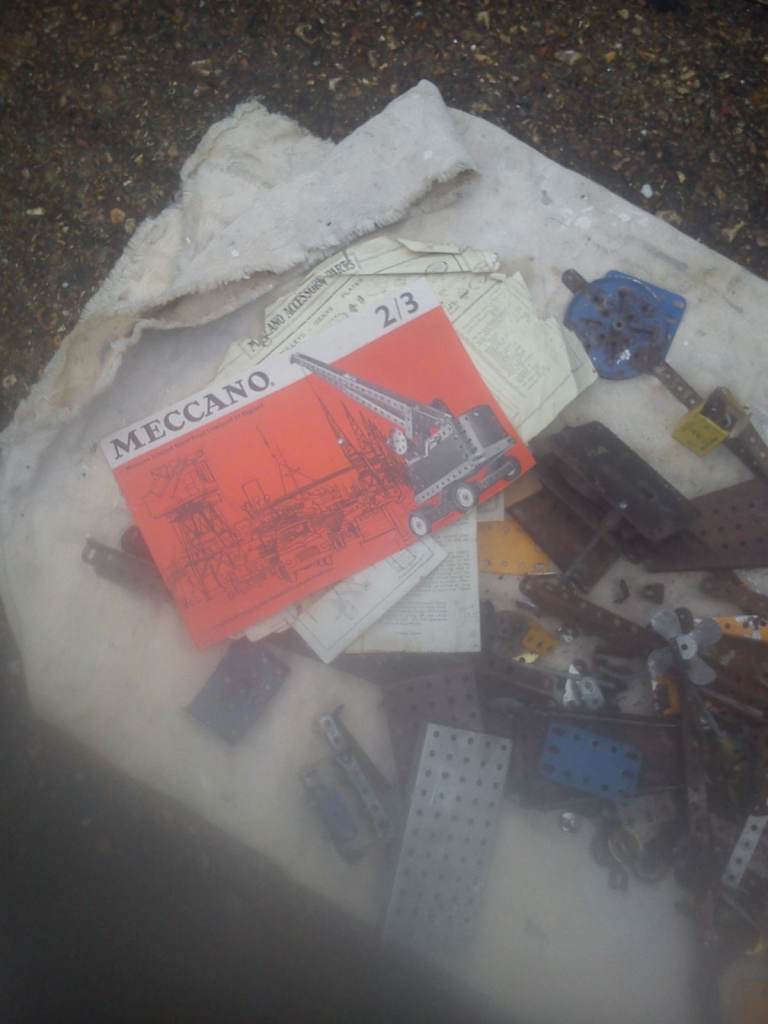 Vintage meccano pieces and literature.