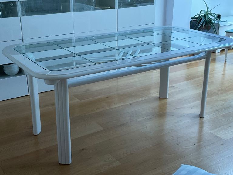 White Italian design glass table with eight matching chairs