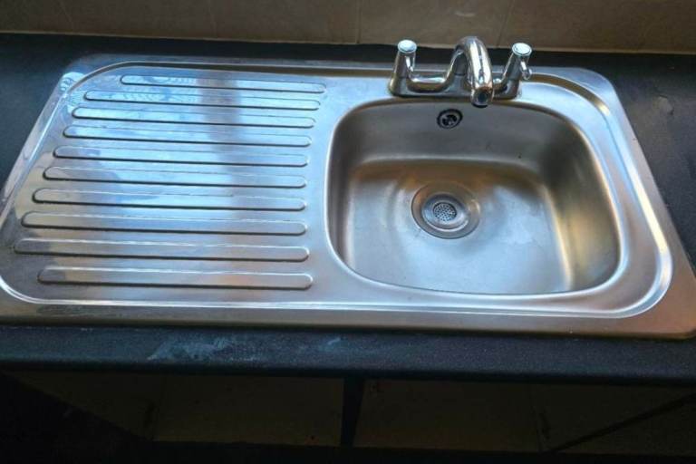 Robust kitchen sink with taps