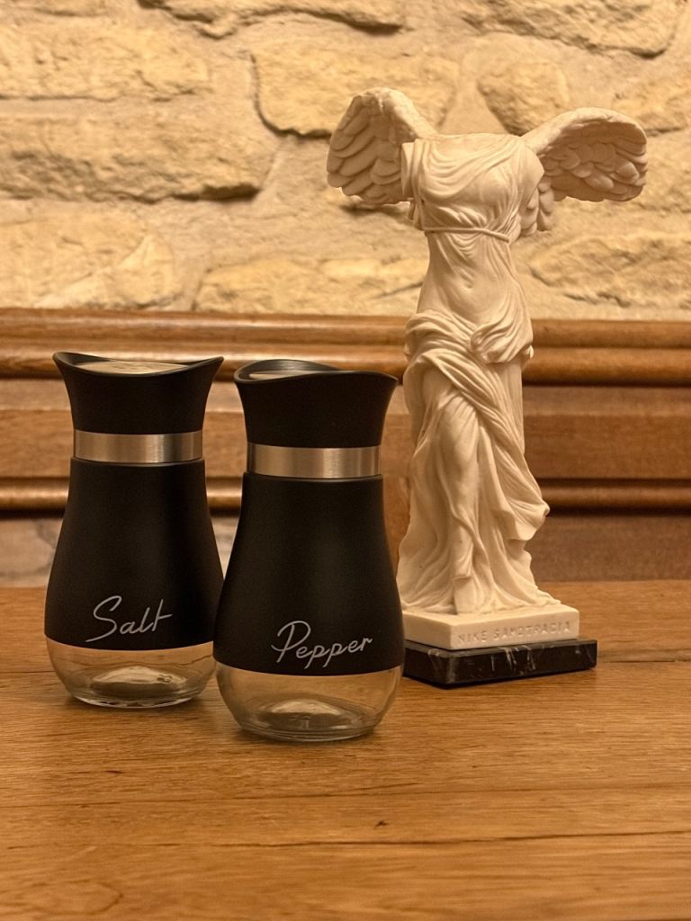 Brand New Set of black and glass salt and pepper shakers.