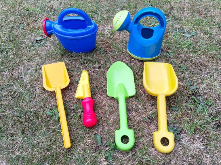 2 kids toy watering can and random gardening tools plastic