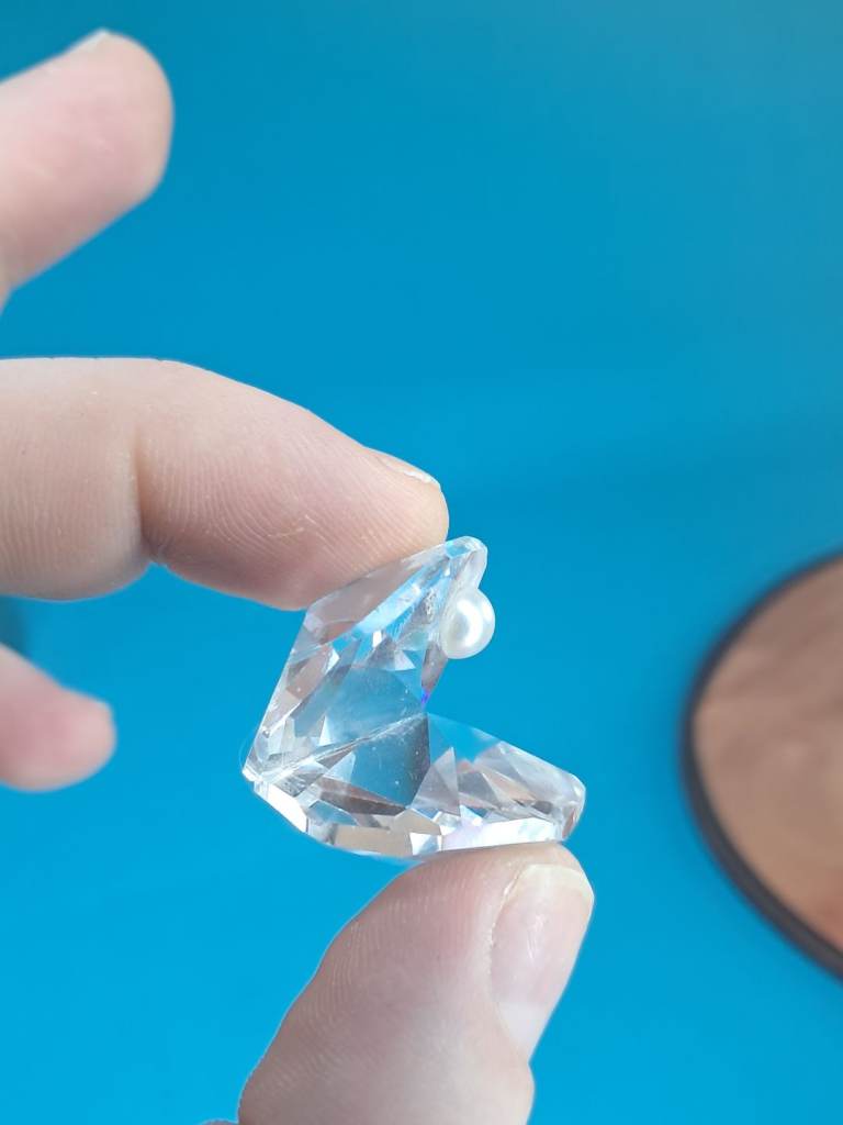 This is a vintage Swarovski cut glass crystal oyster shell with a pearl figurine. 