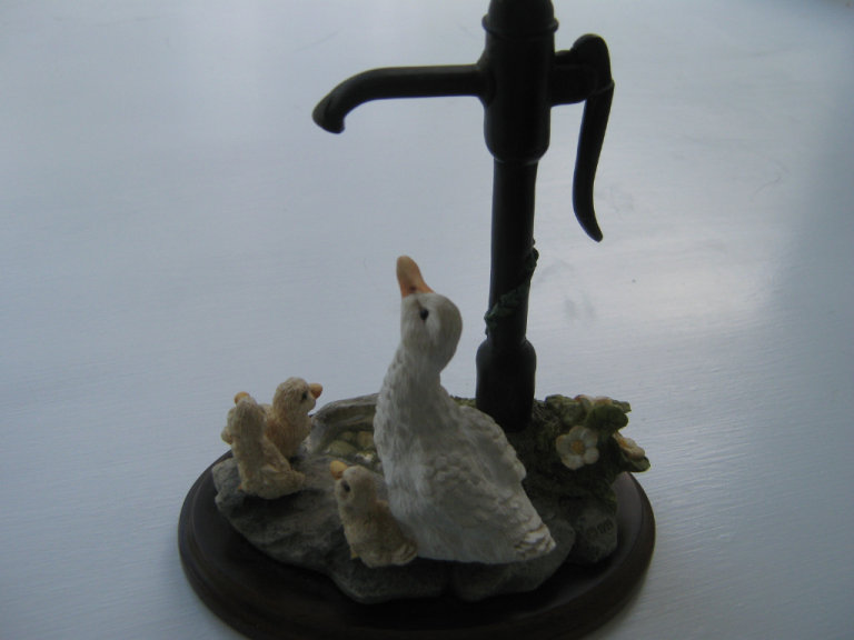 Ornament of a duck and ducklings at a water pump.