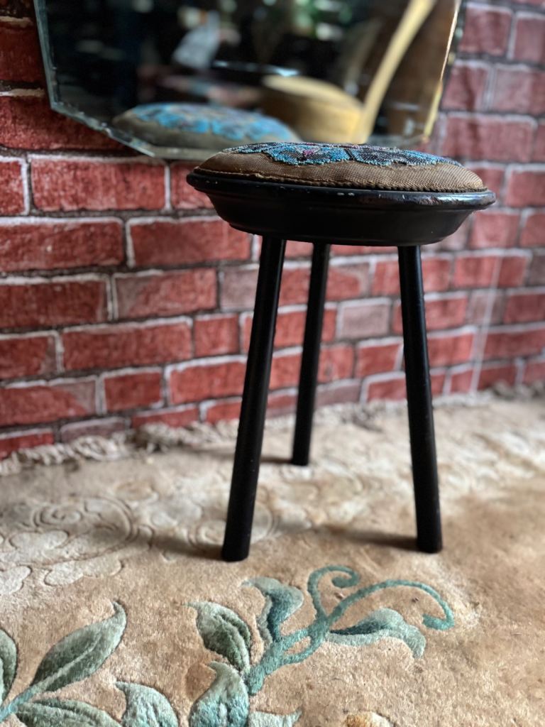  An Antique 3 legged ebonised wooden stool with round embroidered upholstered seat,Top.