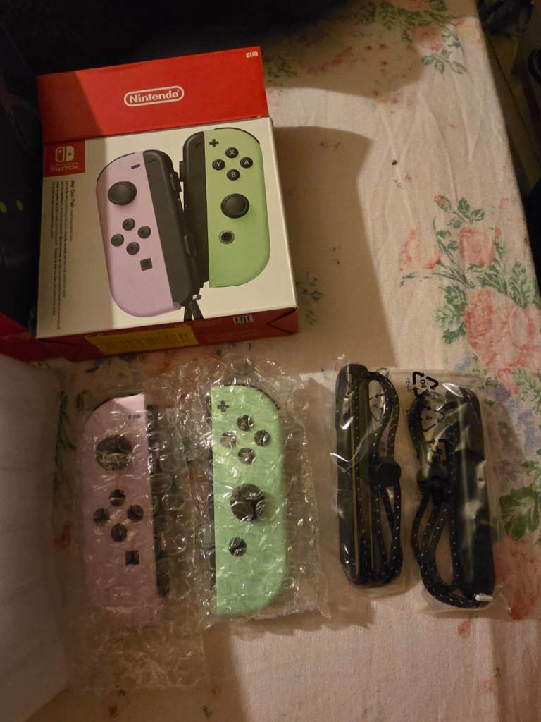 One Brand new set of Joy-Con switch controllers with controller straps 