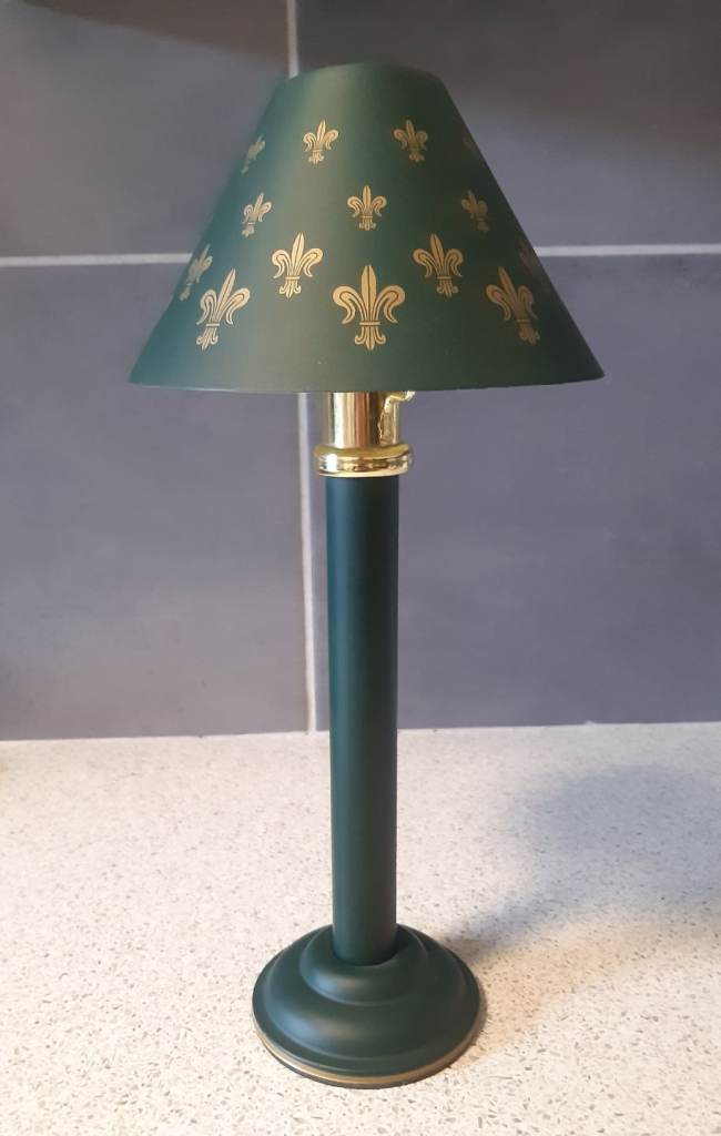 Spring-loaded green/gold candlestick