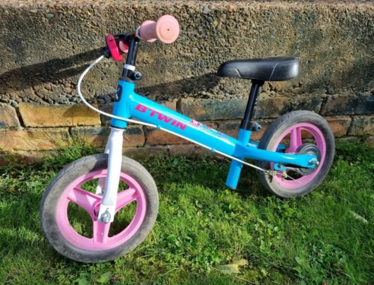 B Twin balance bike light blue frame pink wheels and grips great condition 