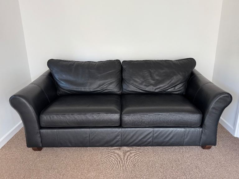 Large black leather sofa from           M & S, Baker Street